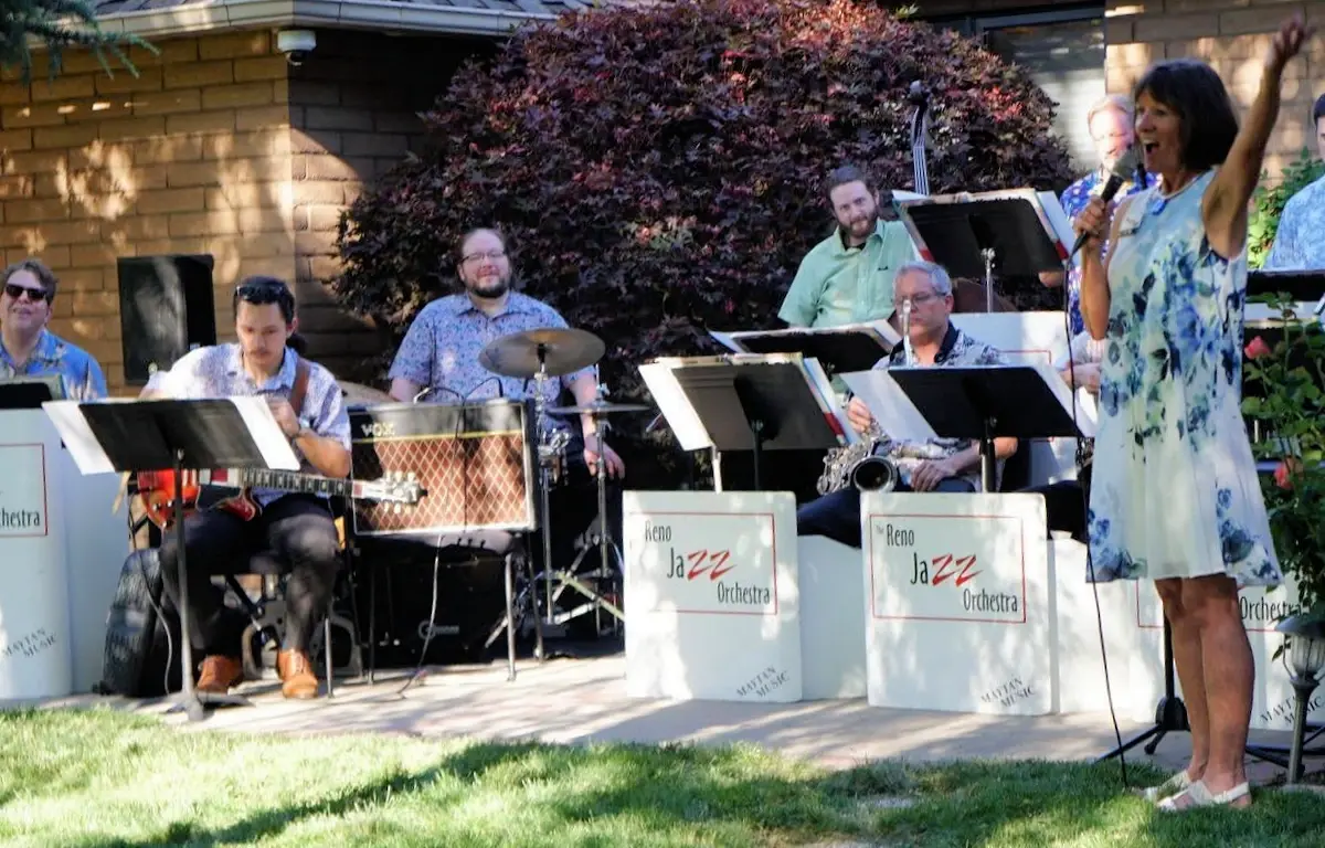 RJO ensemble playing outdoors on a suburban lawn.