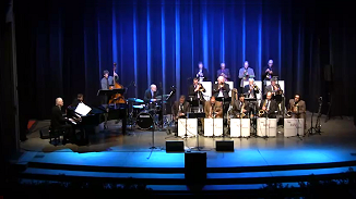 Reno Jazz Orchestra title above a photo of the Orchestra playing live on stage